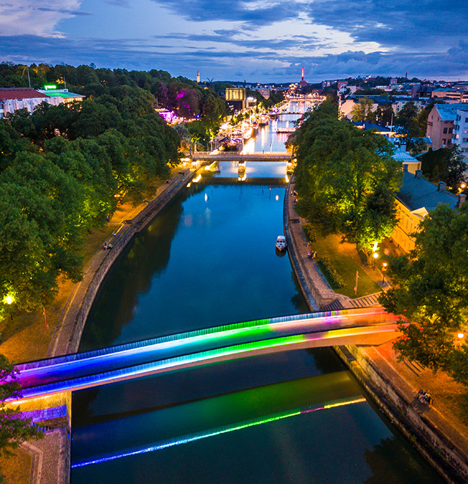 Aerial picture of River Aura and its colourful bridges in the center of Turku in the night time.
