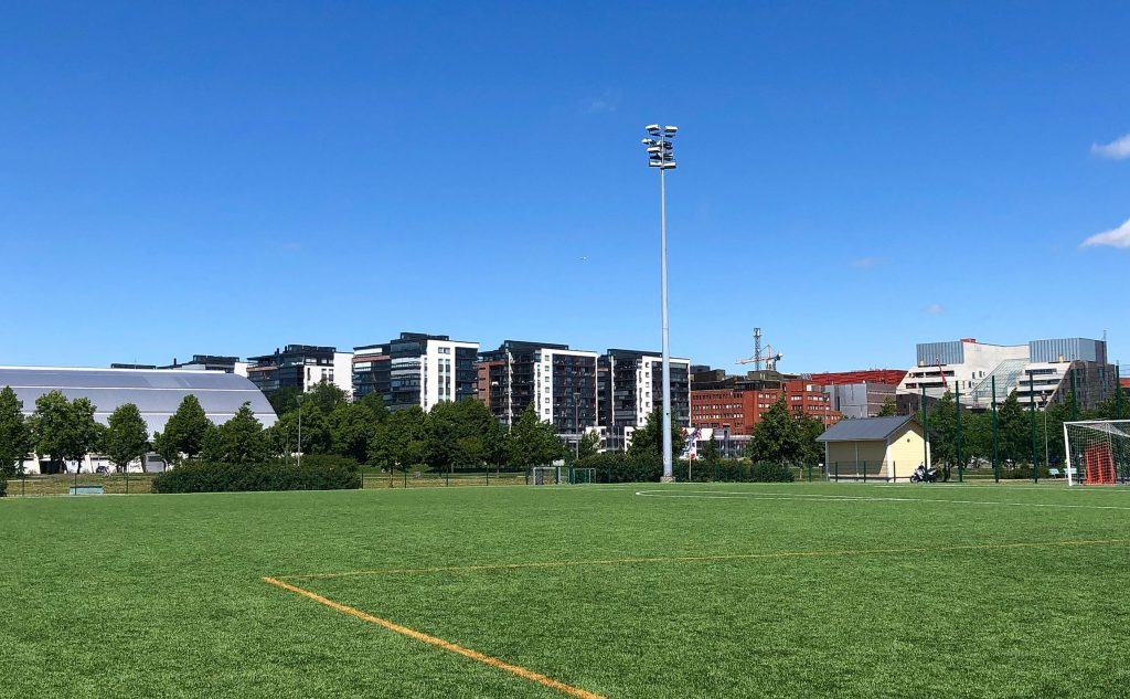 Football court in Kupittaa Park and new apartment building in the background.