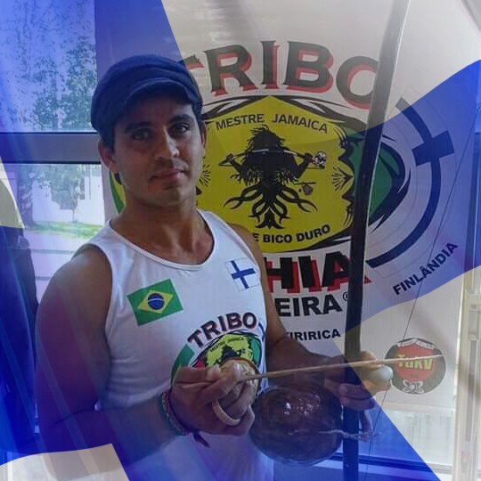 Instructor of capoeira in Turun Kisa-Veikot, Gustavo, has an instrument called berimbau in his hands.