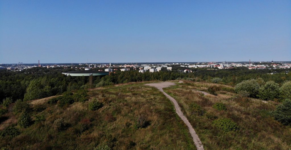 Aerial picture on top of the hill of Luolavuori. There is a top of Luolavuori hill, popular walking route and the city of Turku spreading in the horizon. 