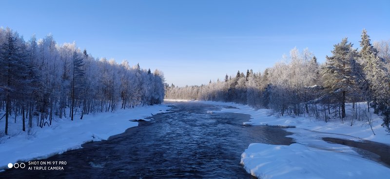 A flowing river in snowy Lapland.