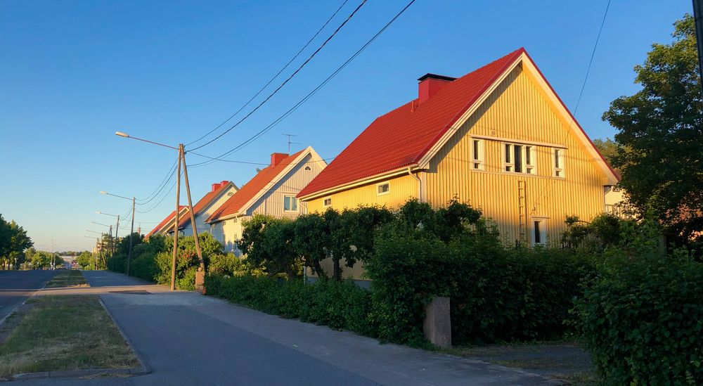 Wooden yellow detached house in the sun set in Turku in the neighbourhood of Vasaramäki