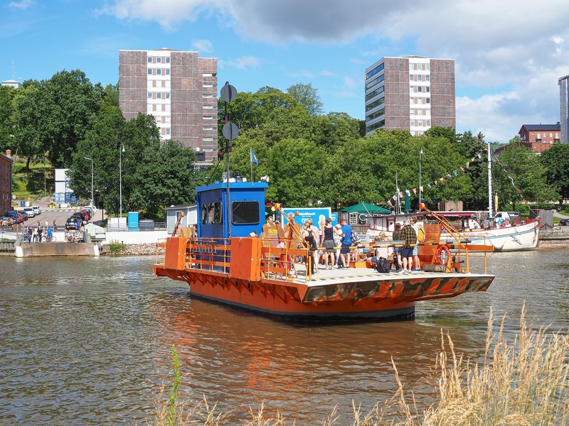 Blue-orange city ferry Föri crossing Aurajoki in Turku.