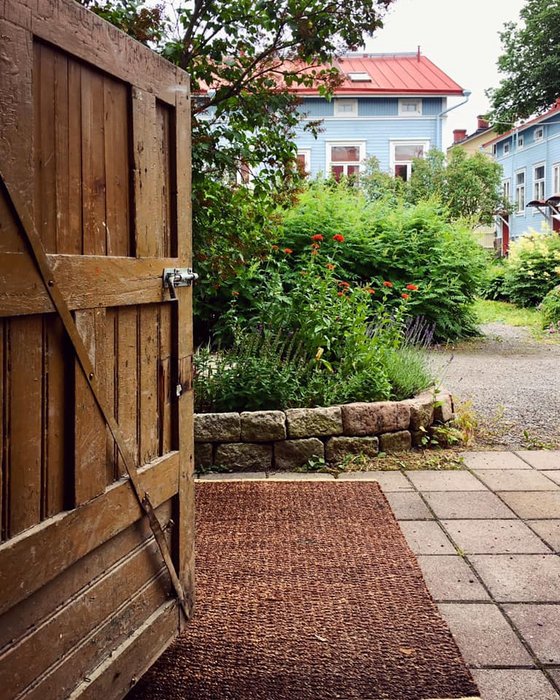 Open wooden door and a view of Port Arthurs wooden houses.