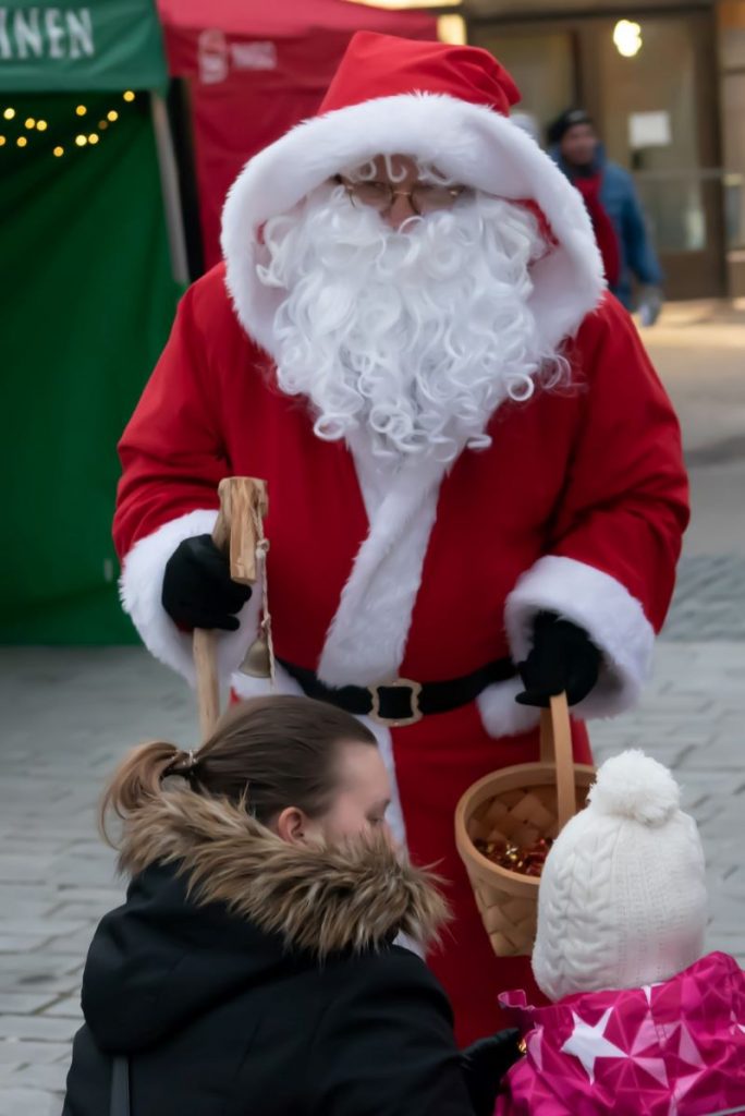 Santa Claus is meeting a young girl and her mother