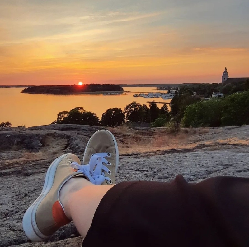 The photographer's feet and the view of Naantali's Old Town harbour.