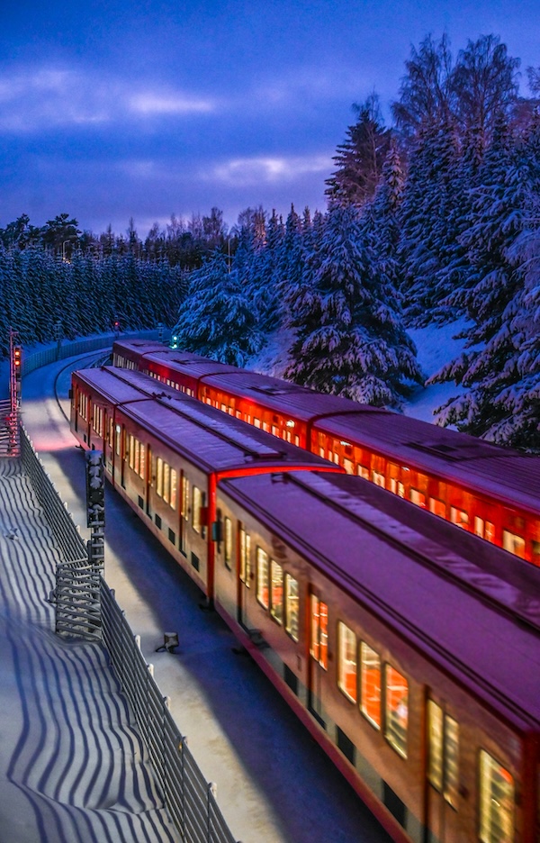 A train speeds through a snowy landscape.