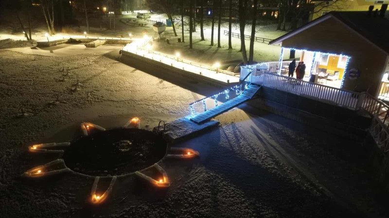 Naantalin Merimaskun rantamakasiinin lyhdyin valaistu avanto ja taustalla rakennus.